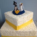 Square cake with elegant piping and ribbon border
