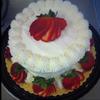 Vanilla layered cake with cream cheeese frosting and strawberries